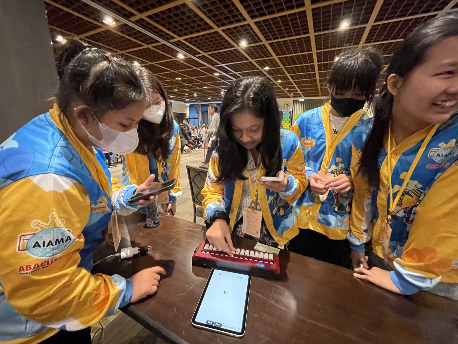 Abacus Olympiad competitors trying the Undugu smart abacus at AIAMA 2026